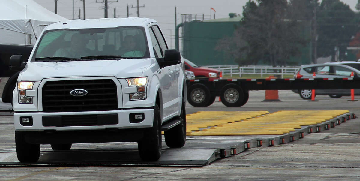 A 2015 Ford F-150 -- which gets improved fuel mileage because of its lighter aluminum body -- rolls off a testing device during a demonstration for dealers at Sam Houston Race Park Thursday, Dec. 4, 2014, in Houston. ( James Nielsen / Houston Chronicle )