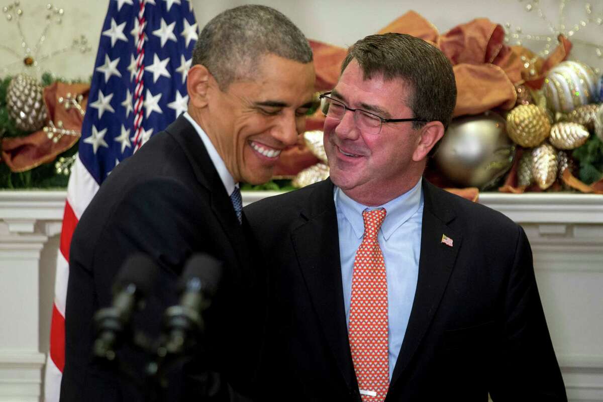 Ashton Carter, former deputy secretary of defense and U.S. President Barack Obama's nominee to be U.S. secretary of defense, right, talks to U.S. President Barack Obama, during a nomination announcement in the Roosevelt Room of the White House in Washington, D.C., U.S., on Friday, Dec. 5, 2014. Carter, 60, spent more than two years as the Defense Department's No. 2 civilian leader under former Secretary Leon Panetta and then Chuck Hagel, the current defense secretary. He also served under Obama's first Pentagon chief, Robert Gates, as the military's top weapons buyer. Photographer: Andrew Harrer/Bloomberg *** Local Caption *** Ashton Carter; Barack Obama; Joe Biden