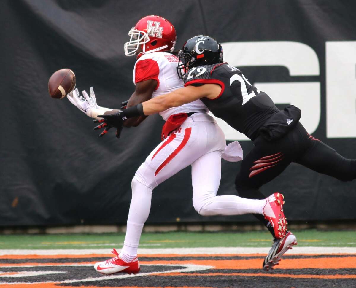 Cincinnati's Andre Jones keeps Houston's Deontay Greenberry from catching a touchdown pass during the first half of an NCAA college football game Saturday Dec. 6, 2014, in Cincinnati. (AP Photo/Tom Uhlman)