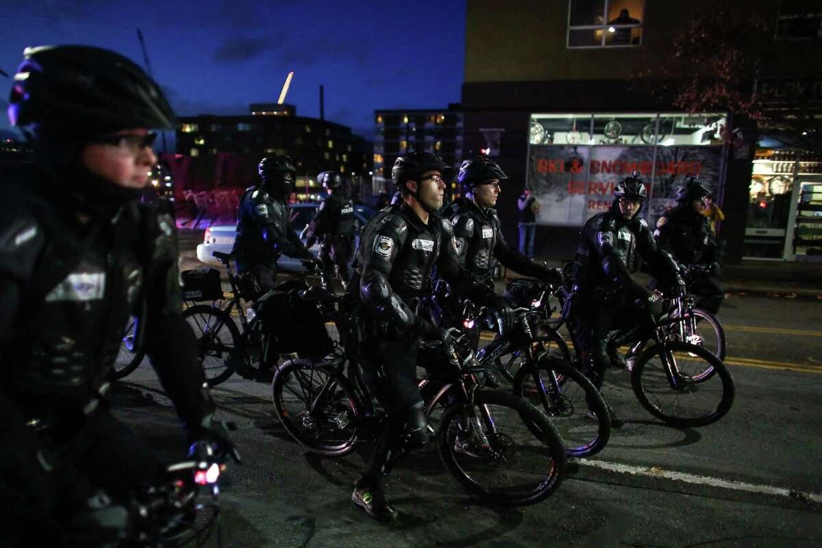Police follow marchers during a protest against police brutality as they announce for the group to disperse or face arrest. Protesters took to Seattle streets once again to protest the recent deaths of black men at the hands of police in the U.S. The protest, mostly led by Garfield High School and University of Washington students, marched through Seattle for hours on Saturday, at one point stopping at Seattle Police headquarters.