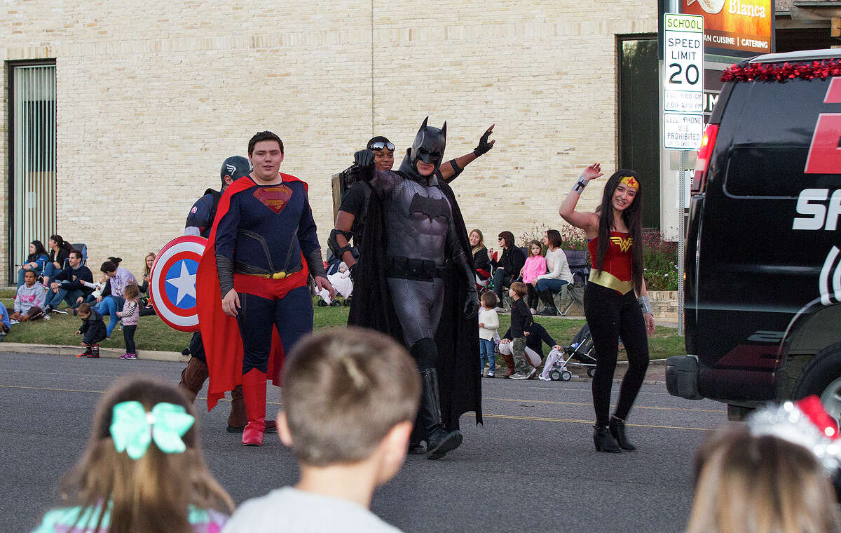Superheroes Batman, Superman and Wonder Woman at the 37th annual Alamo Heights Holiday Parade on Broadway, Saturday, Dec. 6, 2014.