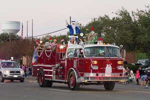 Santa rides in on a fire truck at the 37th annual Alamo Heights Holiday Parade on Broadway, Saturday, Dec. 6, 2014.