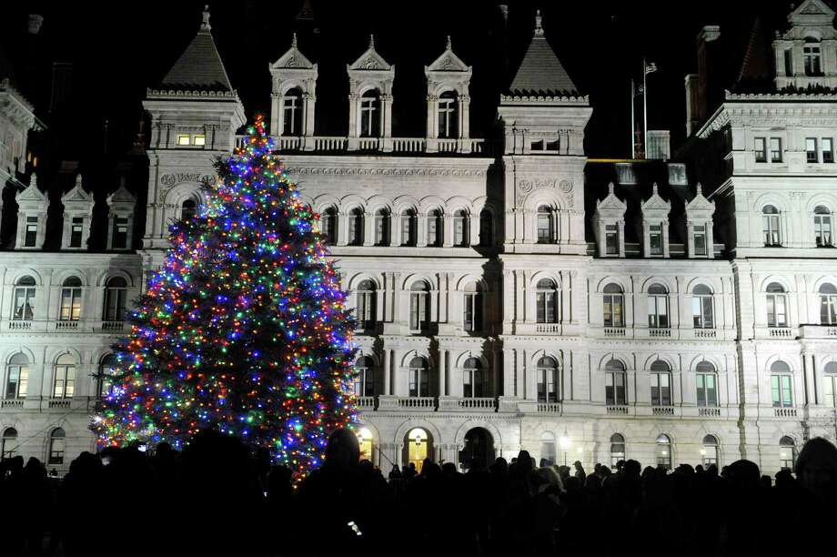 people gather around the holiday tree outside the capitol during the tree lighting ceremony for the - New York Christmas Tree Lighting 2014 people gather around the holiday tree outside the capitol during the tree lighting ceremony for the - New York Christmas Tree Lighting 2014
