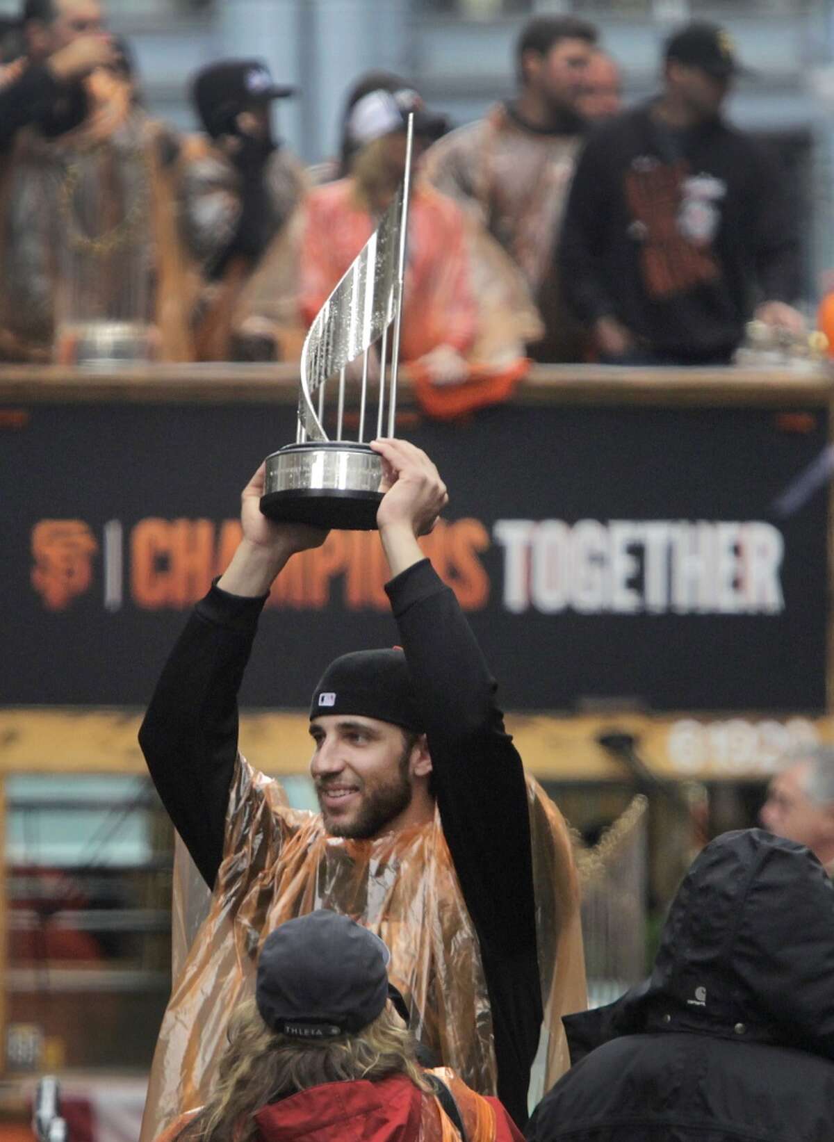 Madison Bumgarner hoists one of his postseason MVP trophies during the Giants' World Series victory parade in San Francisco, Calif. on Friday, Oct. 31, 2014. The Giants captured their third championship in five years after defeating the Kansas City Royals in a seven-game series.