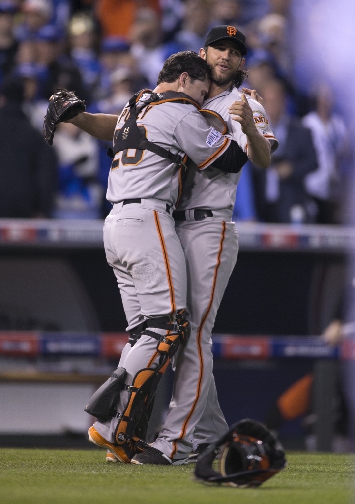 San Francisco Giants pitcher and World Series MVP Madison Bumgarner (R)  hugs his catcher Buster Posey after the final out in game 7 of the World  Series at Kauffman Stadium in Kansas