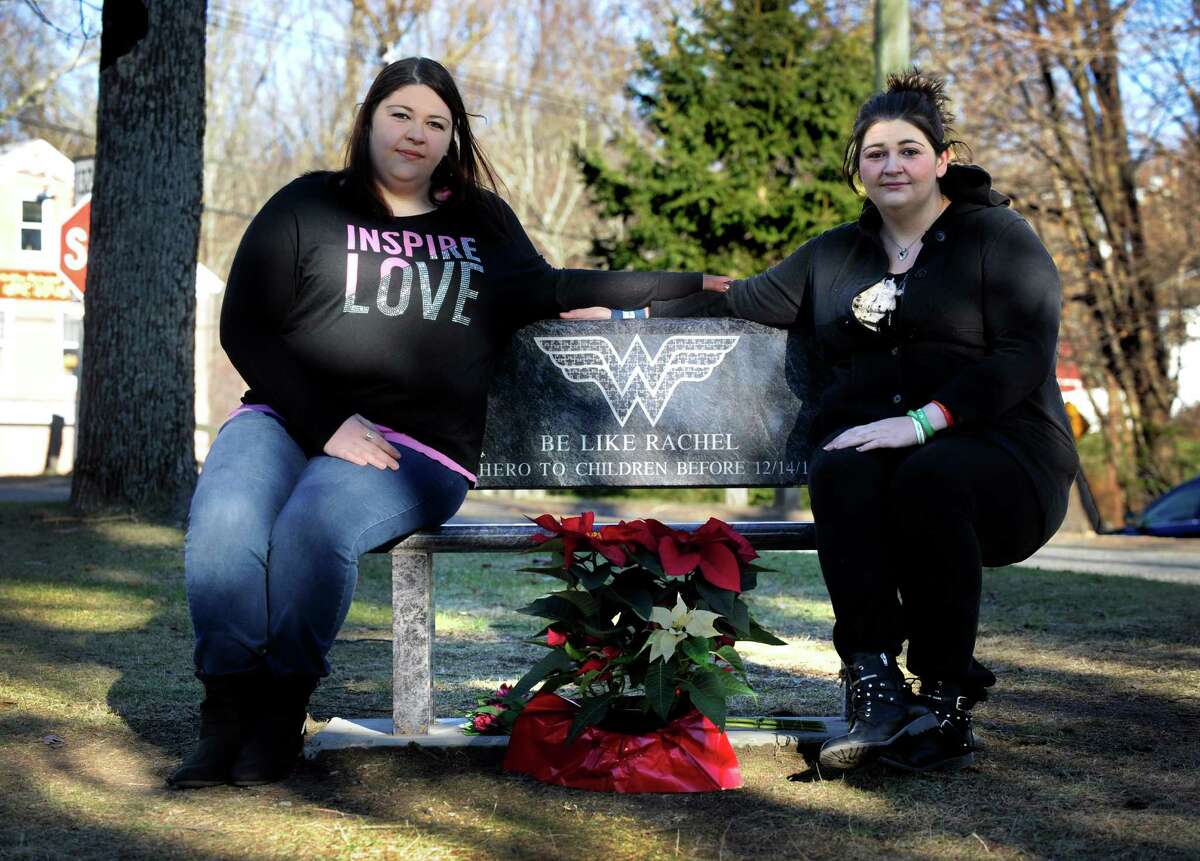 Sarah D'Avino, 27, left and Hannah D'Avino, 24, are the sisters of Sandy Hook Elementary School victim, Rachel D'Avino. The sisters are photographed with a bench dedicated to Rachel on the town green in Bethlehem, Conn., their home town, Sunday, Dec. 7, 2014.