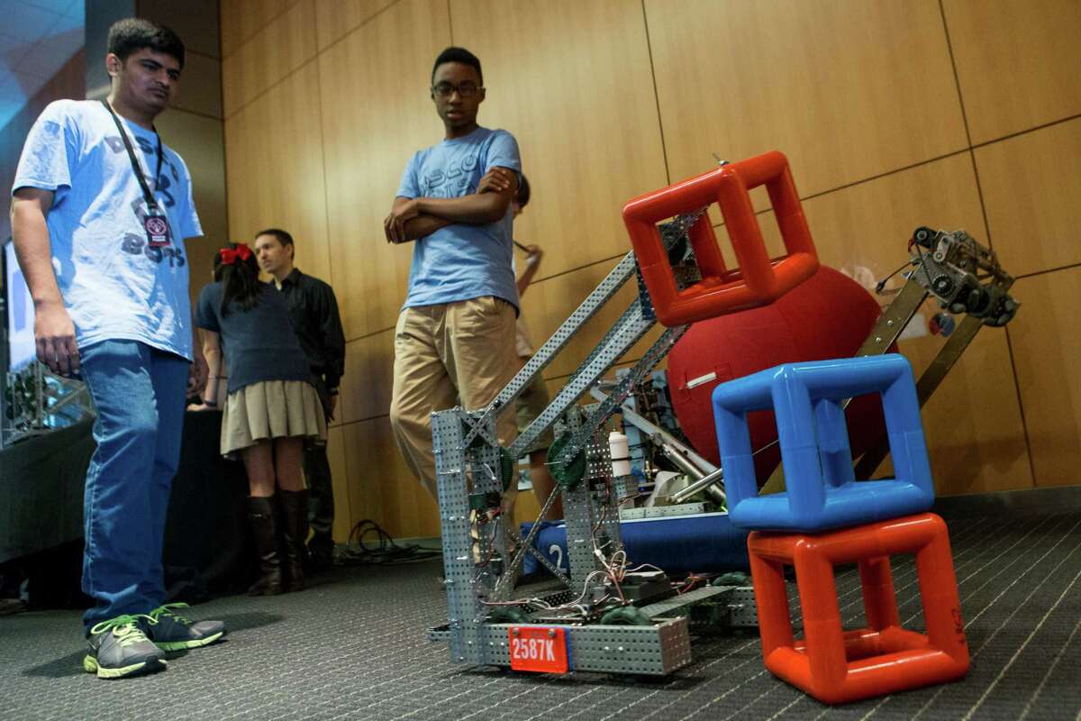 Lamar students demonstrate their robot during the 8th Pipes and Pumps conference at Houston Methodist Research Institute on Monday, Dec. 8, 2014, in Houston. The annual conference highlights crossover technologies between the medical, oil and gas, and space industries. ( Brett Coomer / Houston Chronicle )