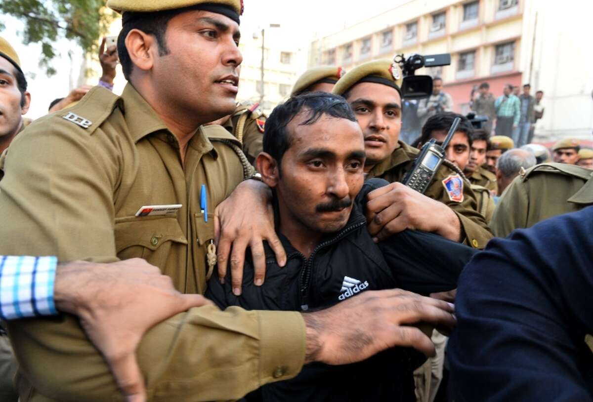 Police escort Shiv Kumar Yadav, who is accused of rape, after his court appearance in New Delhi.