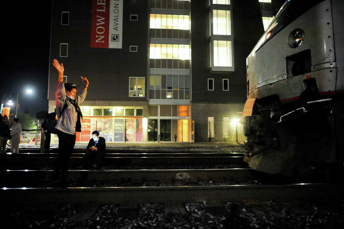 UC Berkeley student Zaynab Abdulqudir stands in front of an Amtrak train as protestors demonstrate against grand jury decisions in Ferguson and New York, in Berkeley, CA, on Monday, December 8, 2014.