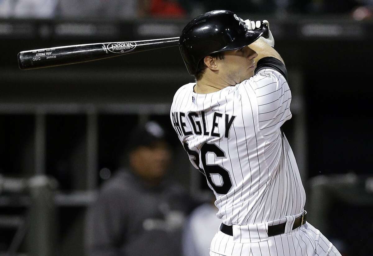 Chicago White Sox's Josh Phegley (36) follows through on a solo home run against the Kansas City Royals during the seventh inning of a baseball game in Chicago on Saturday, Sept. 27, 2014.