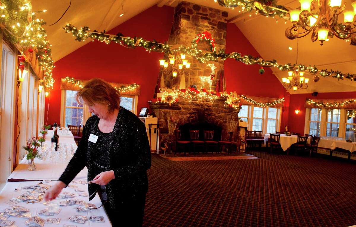 Executive Vice President Barbara Seiter organizes nametags in preparation for the Stamford Chamber of Commerce's annual holiday party at Zody's 19th Hole in Stamford, Conn., on Tuesday, December 9, 2014.