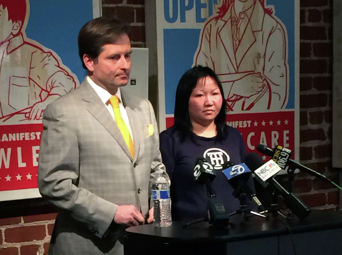 Attorney Christopher Dolan, left, and Huan Kuang address the media during a press conference on December 9, 2014 in San Francisco, California, regarding the sentencing the Uber driver who struck Kuang and her two children, killing her six-year-old daughter, Sofia Liu. The driver, Syed Muzaffar, 57, of Union City, is charged with misdemeanor vehicular manslaughter in connection with the crash.