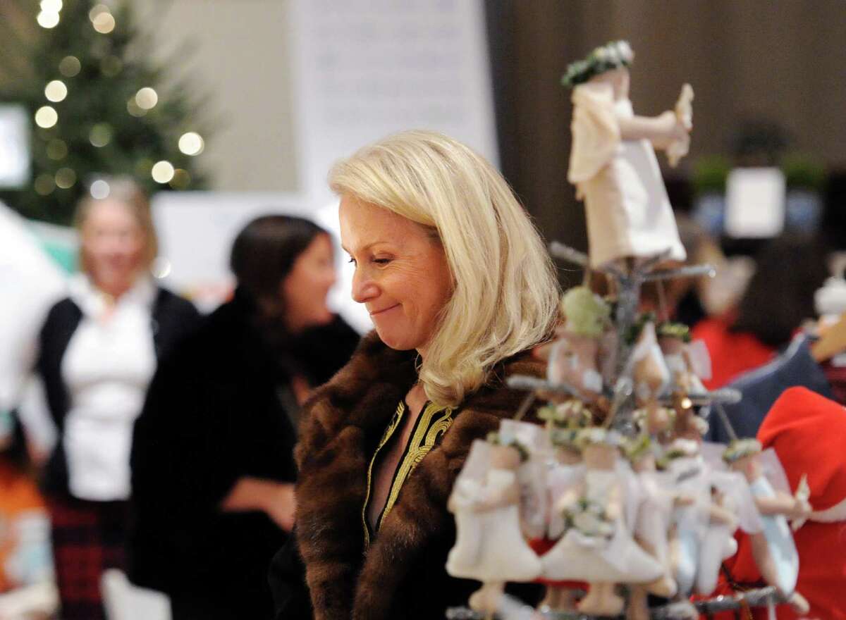Mary Pat Cabrera of Greenwich smiles while shopping during the Antiquarius Holiday Boutique at Christ Church Greenwich Parish Hall, Tuesday night, Dec. 9, 2014. The Greenwich Historical Society sponsors the event that will also be held on Wednesday, Dec. 10, from 9 a.m. to 6 p.m. at Christ Church Greenwich.