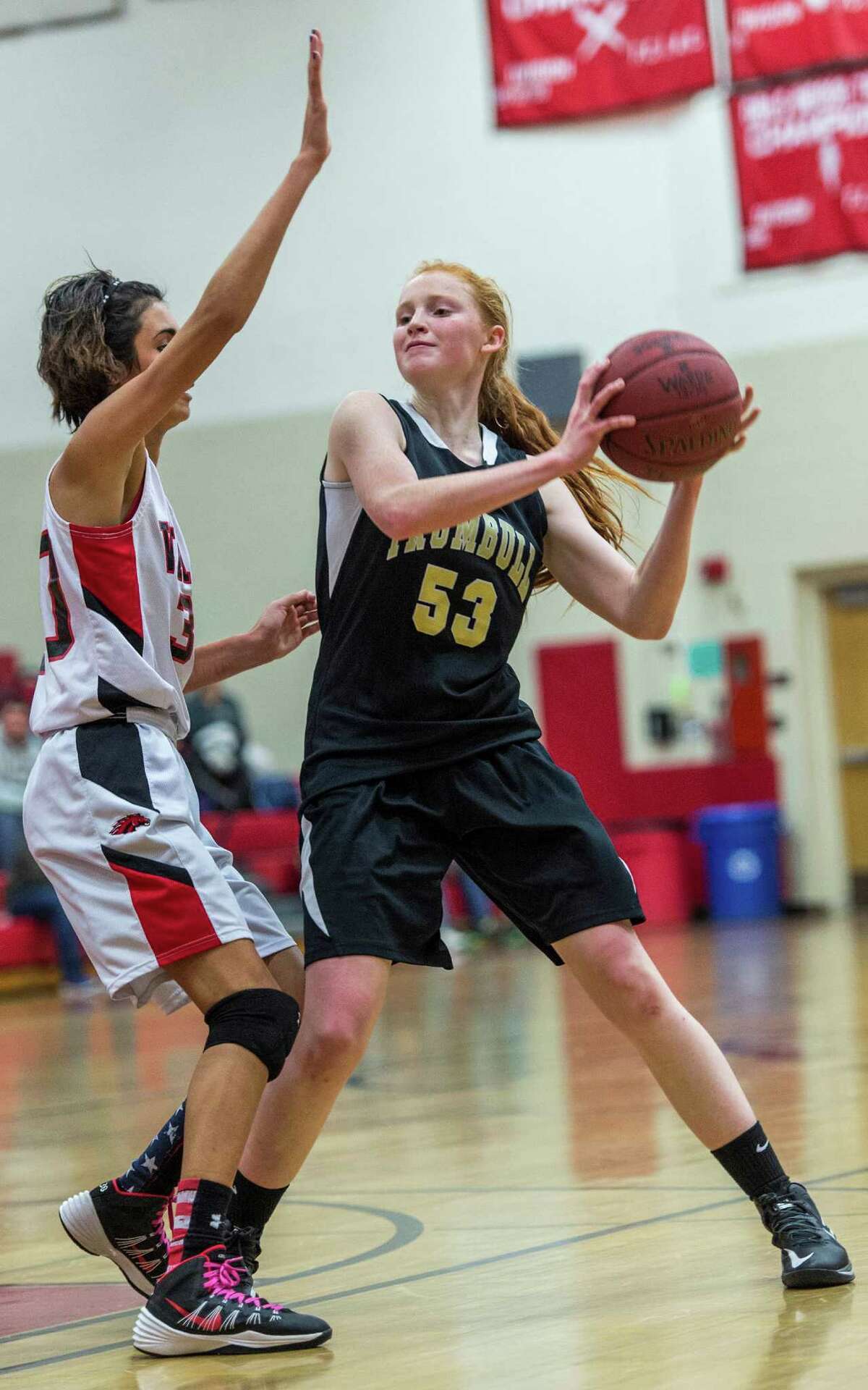 Trumbull high schoolâÄôs Taylor Brown looks for a teammate to pass to during a girls basketball game against Fairfield Warde high schoolâÄôs played at Warde high school, Fairfield, CT on Wednesday, December 9th, 2014.
