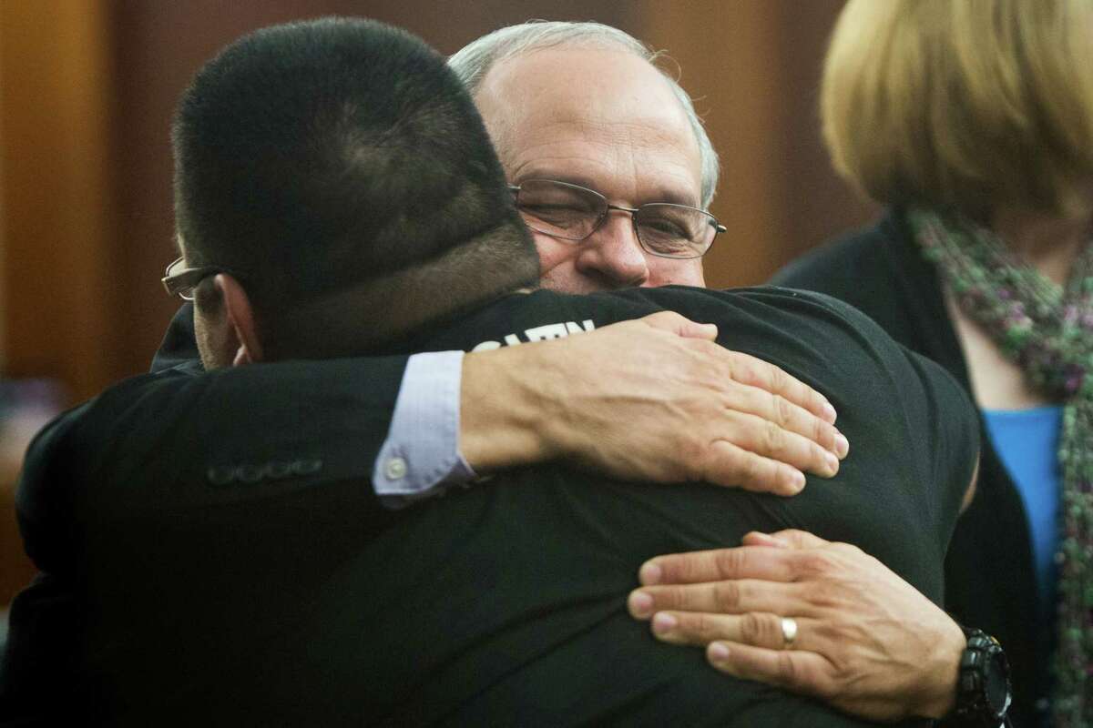 Randy Norman, father of Chelsea Norman, hugs cyclist Ricardo Martinez after Wednesday's verdict.