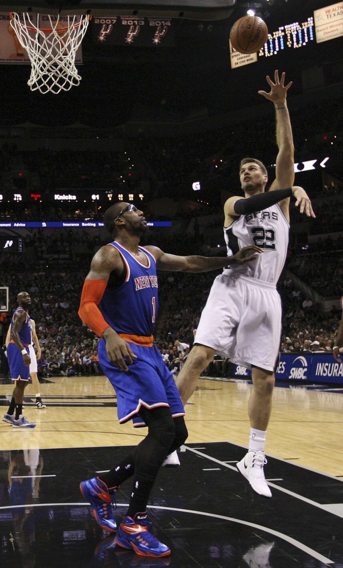 San Antonio Spurs' Tiago Splitter shoots over New York Knicks' Amar'e Stoudemire during the second half at the AT&T Center, Wednesday, Dec. 10, 2014. The Spurs won 109-95.