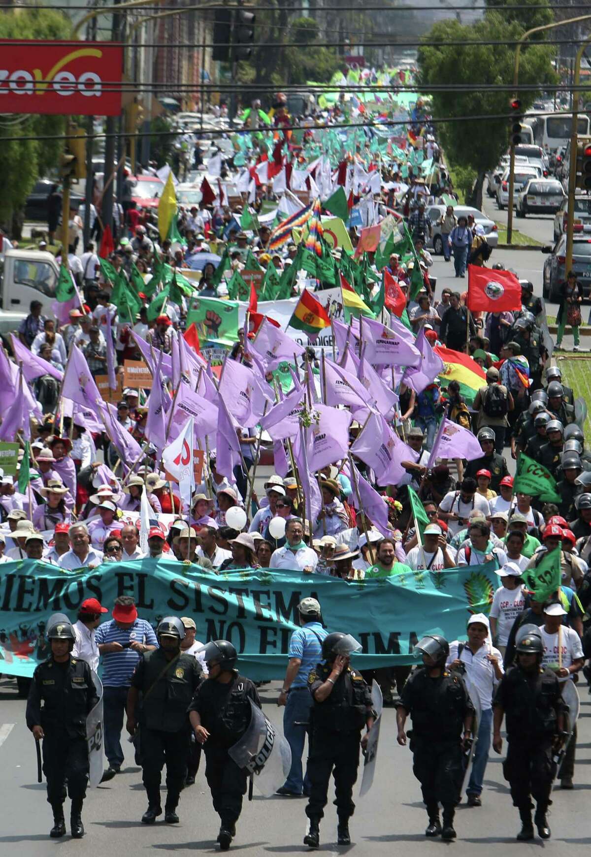 Thousands march in “Defense of Mother Earth” in Lima, Peru, during the summit on Wednesday.