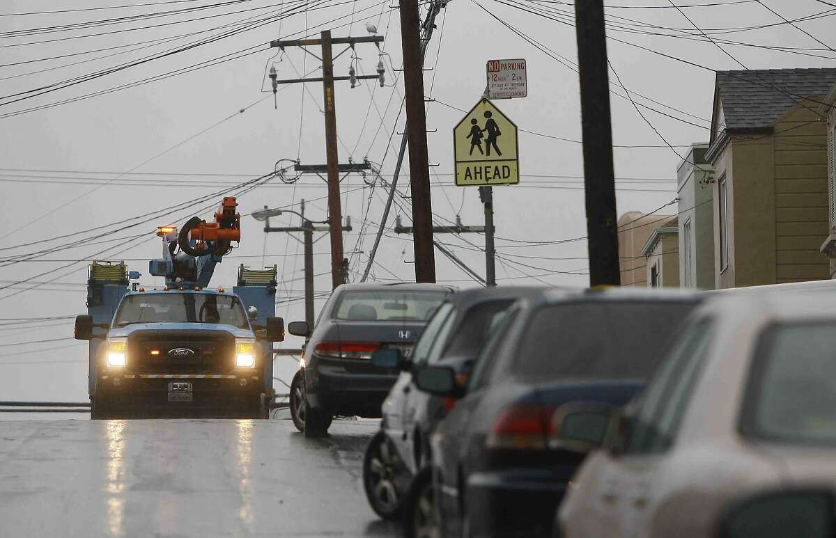 PG&E crews work to repair a blown transformer near 42nd Street and Taraval Street in the Sunset District of San Francisco, Calif. Thursday, December 11, 2014 during the biggest storm to hit the Bay Area in 6 years