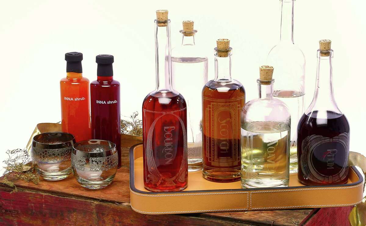 A spirited affair: INNA shrubs in quince and strawberry; whiskey tumblers; Reclamation Etchworks hand-etched Variance Set" spirit decanters, from $199, www.reclamationetchworks.com.