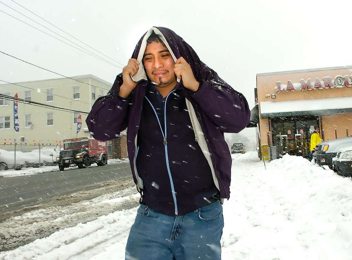 David Morales of Stamford, fights the snow, cold and blowing wind as he walks on West Main Street in Stamford, Friday morning, Feb. 26th, 2010.