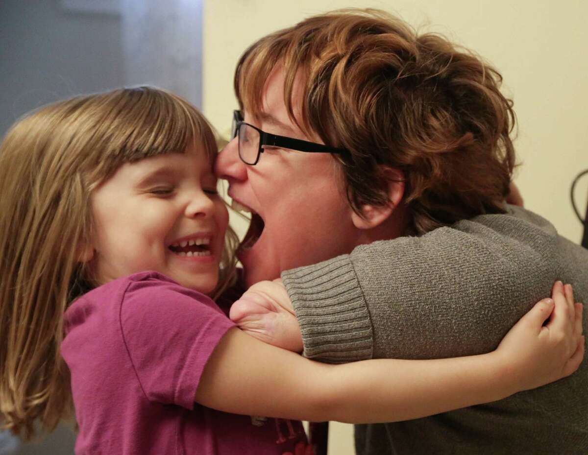 Four year-old Arielle Hayes hugs her mother Katy Hayes at their home in Kingwood.