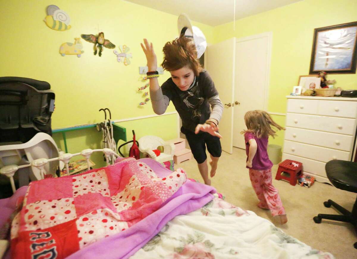 Having plenty of room to run and jump, siblings Jake Hayes, 10, and Arielle Hayes, 4, play in their old rooms Wednesday Dec. 10, 2014, in Kingwood. Katy Hayes and her family have returned home after spending over two years in Boston waiting for a double arm transplant. The surgery was to be performed at Boston's Brigham and Women's Hospital in what was to be the first such procedure performed in the United States. Due to financial struggles the Hayes family was forced to move back to Texas. (Billy Smith II / Houston Chronicle)