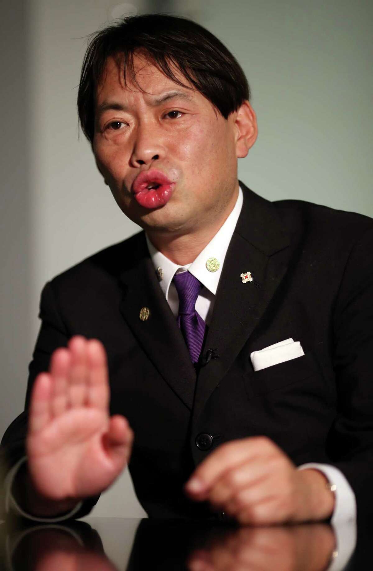 In this Dec. 10, 2014 photo, Mutsuhiro Takeuchi, a nationalist-leaning educator and a priest in the traditional Shinto religion, speaks during an interview with The Associated Press, in Tokyo. Angelina Jolieâs new movie âUnbrokenâ has not been released in Japan yet, but it has already struck a nerve in a country still fighting over its wartime past. (AP Photo/Eugene Hoshiko)