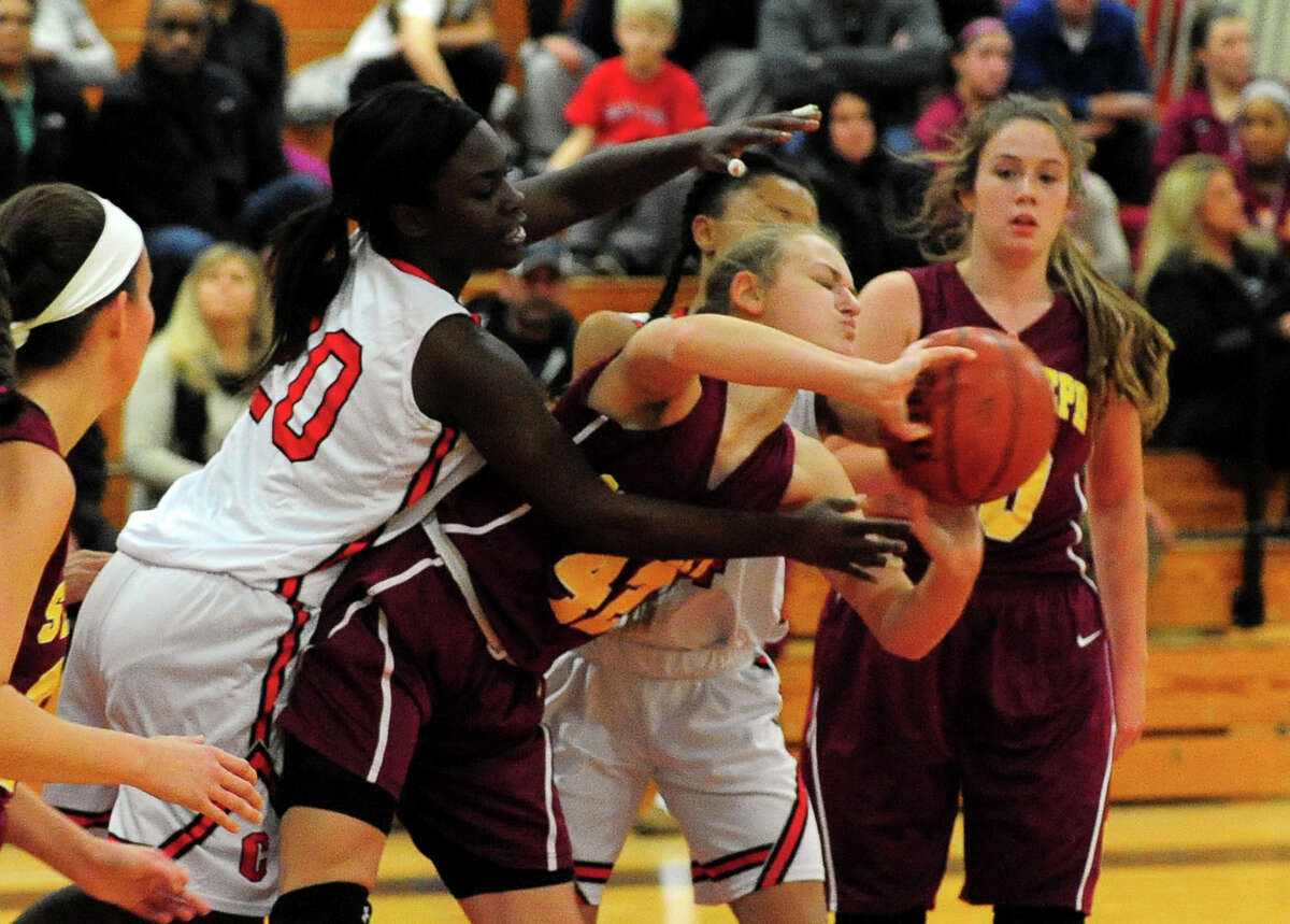 St. Joseph's Jacqueline Jozefick, right, tries to pass the ball before Central's Toni Alves tries to steal, during girls basketball action in Bridgeport, Conn., on Friday Dec. 12, 2014.