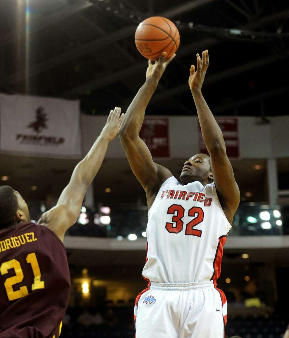 Fairfield University's #32 Anthony Johnson sends the ball to the hoop as Iona's #21 Alejo Rodriguez tries to block, during basketball action at the Arena at Harbor Yard in Bridgeport, Conn. on Friday Feb. 26, 2010.