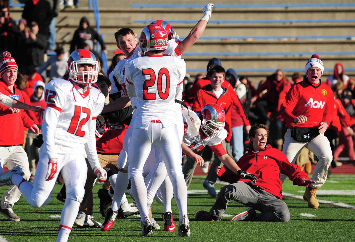 New Canaan celebrates its win over Darien, during Class L State Championship football action in West Haven, Conn., on Saturday Dec. 13, 2014. New Canaan beat Darien 21-20.
