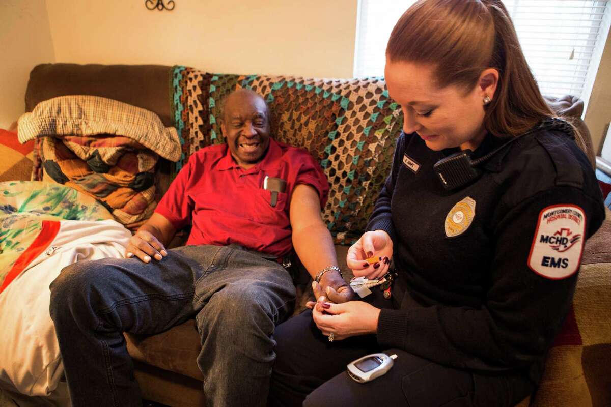 Paramedic Nivea Wheat does a blood sugar test on William﻿ Jones at his Conroe home on Wednesday﻿. ﻿"Community Paramedicine," a new Montgomery County Hospital District program, ﻿has paramedics proactively go out into the community to help recurring 911 users with a range of issues. ﻿