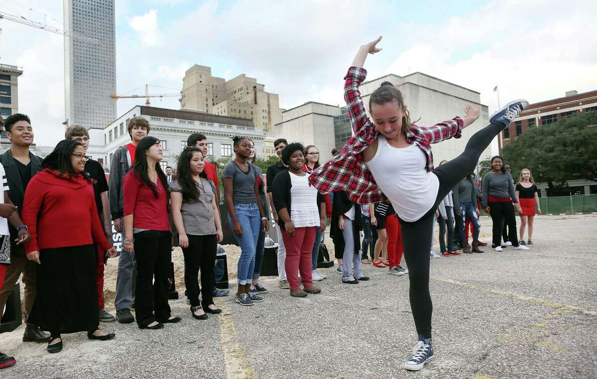 Students from the High School for the Performing and Visual Arts sing and dance at the ground-breaking ceremony on Sunday.