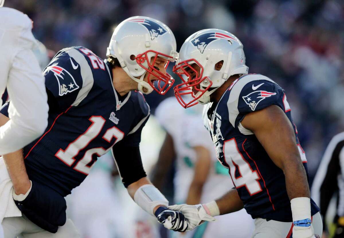 New England Patriots quarterback Tom Brady, left, celebrates a touchdown by running back Shane Vereen, right, in the first half of an NFL football game against the Miami Dolphins Sunday, Dec. 14, 2014, in Foxborough, Mass. (AP Photo/Charles Krupa) ORG XMIT: FBO109