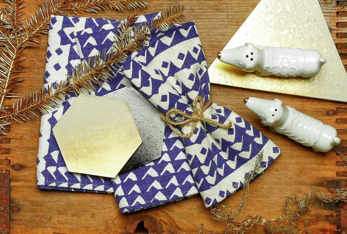 Shake it up with shapes and textures: 45 Wall Design concrete trivet ($19) and coasters ($29 for four), Park and Pond, 1422 Grant Ave., www.45walldesign.com; Jenny Pennywood indigo triangle napkins, $32 for two, www.jennypennywood.com; dachshund salt-and-pepper shaker set, $7.99, Target, 789 Mission St., www.target.com