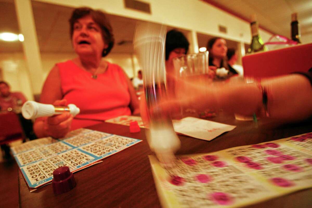 Bingo players watch as numbers are called out during the weekly Bingo game at the SPJST Lodge 88, Thursday, Sept. 2, 2010, in Houston. The elderly are now sharing their bingo nights with young professionals in their twenties and thirties, some of them dressed to kill. At first, it's the prices that attract the younger crowd: $5 to play all night, $1.50 burgers and $6 pitchers of Shiner. But over time, they get sucked in by the intensity of the game -- complete with cheering and booing. These days, you have to arrive early on a Thursday night just to get a seat among the 700 people that come in the door.