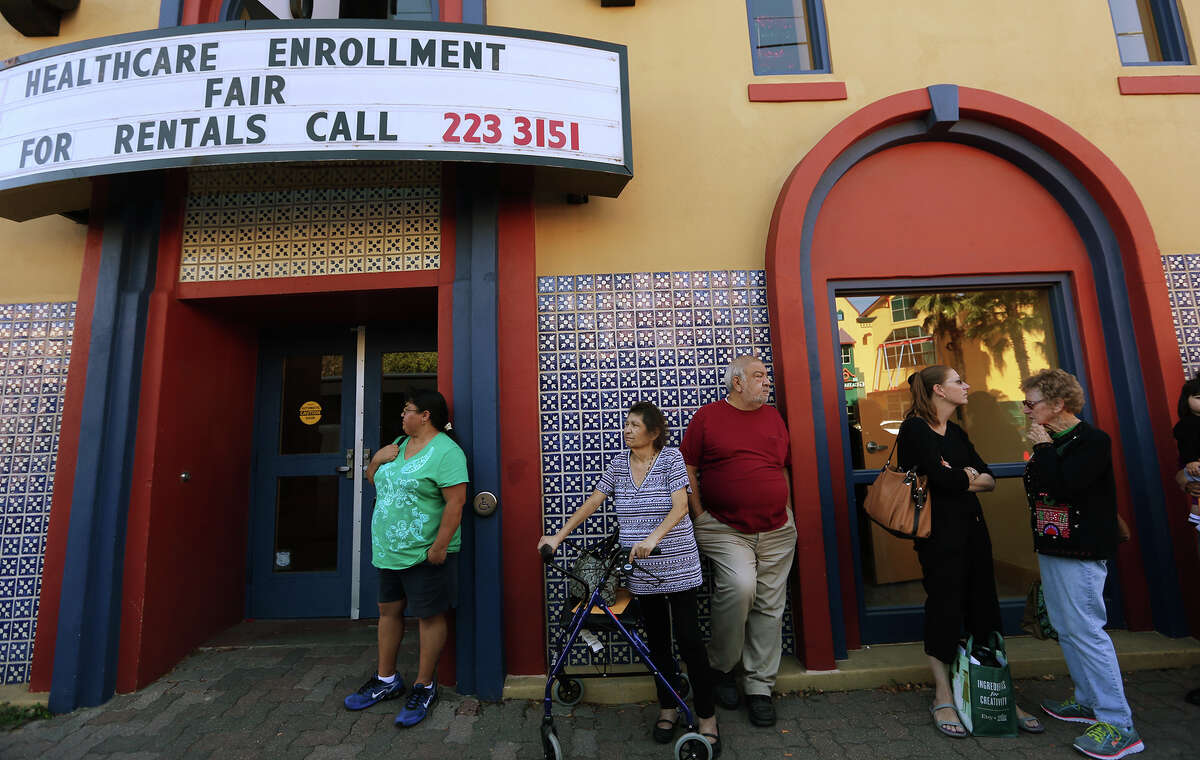 People line up on for a health insurance enrollment event at Progreso Hall on the city's West Side in December 2014. Price increases for plans taking effect Jan. 1 are a result of the health insurance market attracting sicker rather than healthier customers, heavy use of medical services, rising pharmaceutical costs and certain mandates imposed by the Affordable Care Act, experts said.