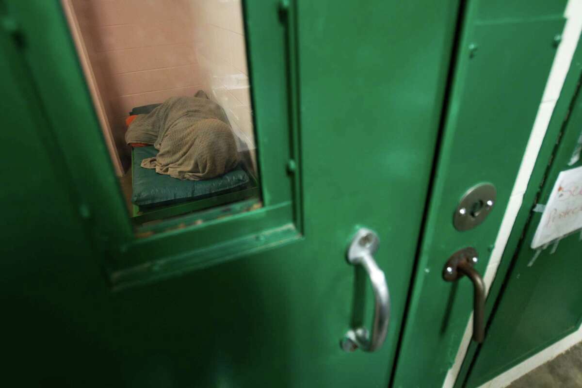 An incarcerated female inmate lies covered in a blanket in a cell in one of the mental health pods at the Harris County Jail Wednesday, April 13, 2011, in Houston. ( Brett Coomer / Houston Chronicle )