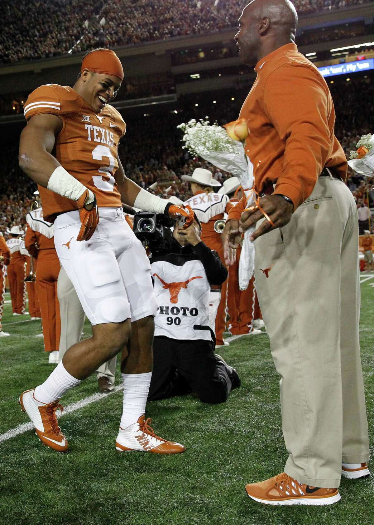 Jordan Hicks #3 of the Texas Longhorns is introduced and meets head coach Charlie Strong as the seniors were honored before playing the TCU Horned Frogs at the Darrell K Royal -Texas Memorial Stadium on November 27, 2014 in Austin. Texas. (Photo by Chris Covatta/Getty Images)