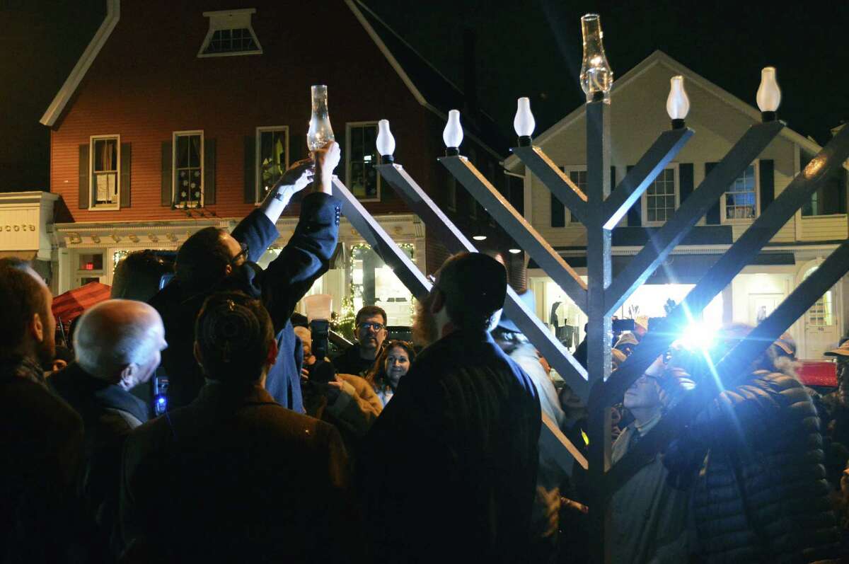 A menorah is lighted downtown during ceremonies marking the start of Hanukkah observances Tuesday evening.