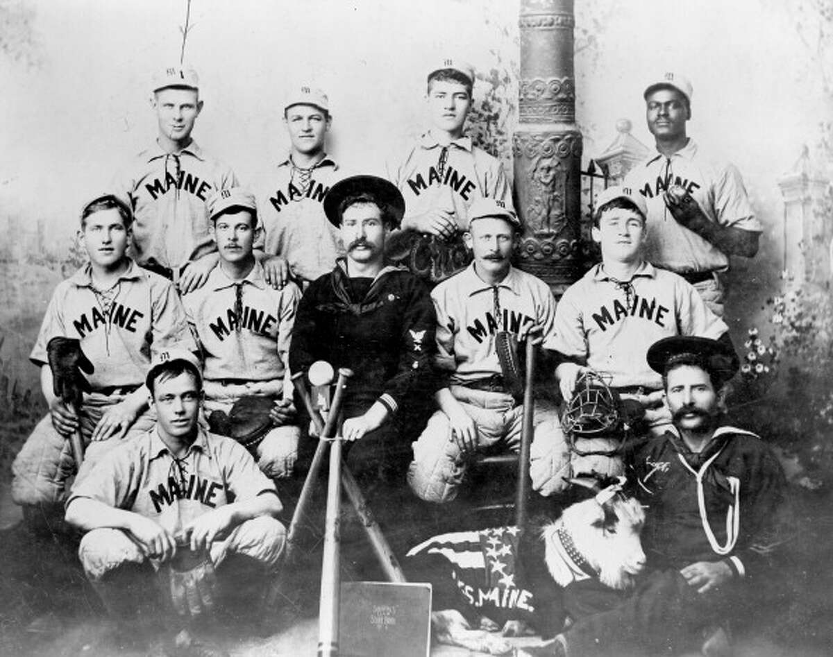 An 1898 group shot of the U.S.S. Maine baseball team which won the previous year's Navy baseball championship. All but one member of the team subsequently perished when the Maine exploded in Havana harbor. African American pitcher William Lambert, back row, far right, was their star player.