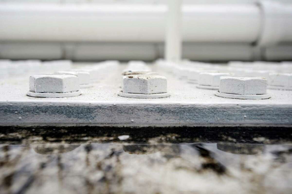 A puddle of water sits next to bolts on top of the Eastern span of the Bay Bridge in Oakland, CA Monday, February 10, 2014.
