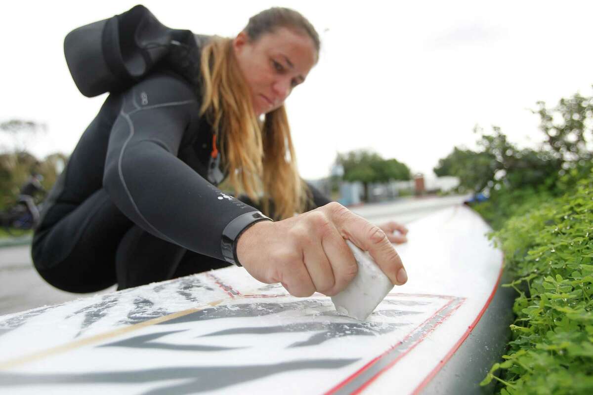 Big-wave surfer Andrea Moller waxes her board. “It was typical NorCal, nasty conditions,” another surfer said.
