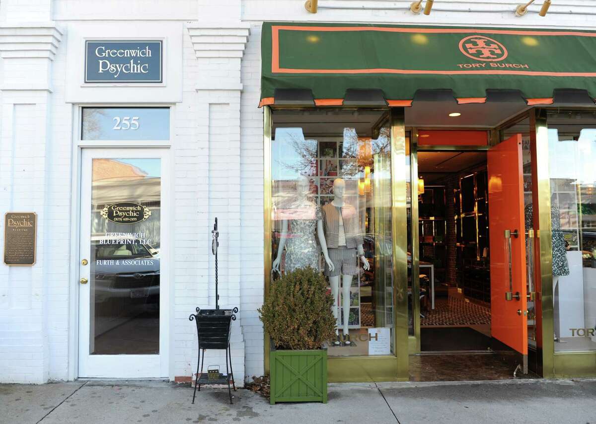 The Greenwich Psychic is mixed in with many high-end retail stores, such as Tory Burch, along Greenwich Avenue in downtown Greenwich, Conn. Wednesday, Dec. 17, 2014. Over the years, many local businesses along the Avenue have been replaced by super high-end stores, changing the look and feel of the downtown area.