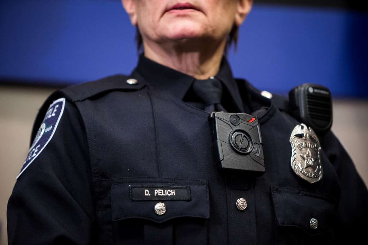 Seattle Police Department officers show off their new body-worn cameras and accompanying new uniforms Thursday, Dec. 18, 2014, at City Hall in downtown Seattle, Washington. (Jordan Stead, seattlepi.com)