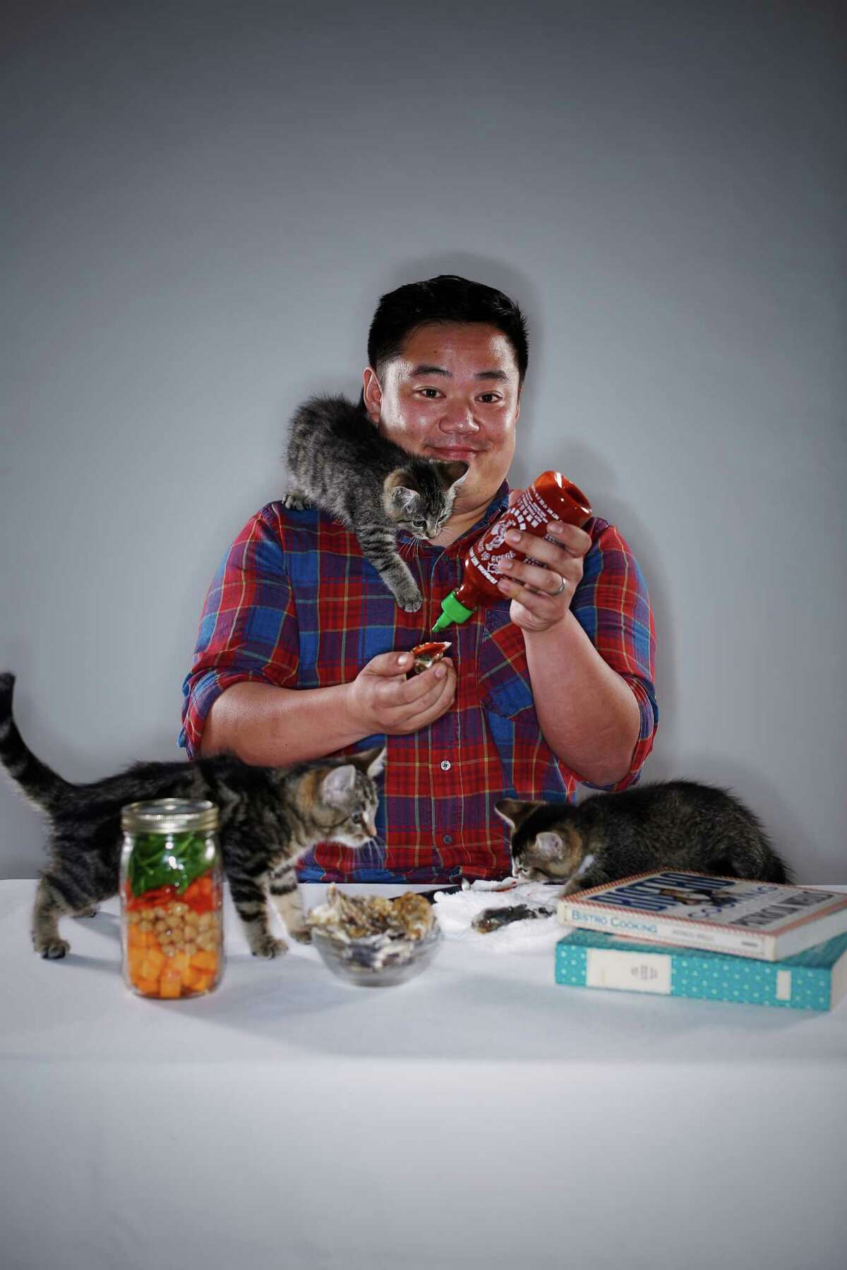Lucky Peach editor Chris Ying gamely shows off this year’s food trends. To represent cat cafes, volunteers from the San Francisco SPCA brought 2-month-old Pogo (left), Nerf and Frisbee to the photo shoot at The Chronicle. Each year the SPCA helps more than 5,000 animals find loving homes.Learn more and view available animals at www.sfspca.org/adopt.
