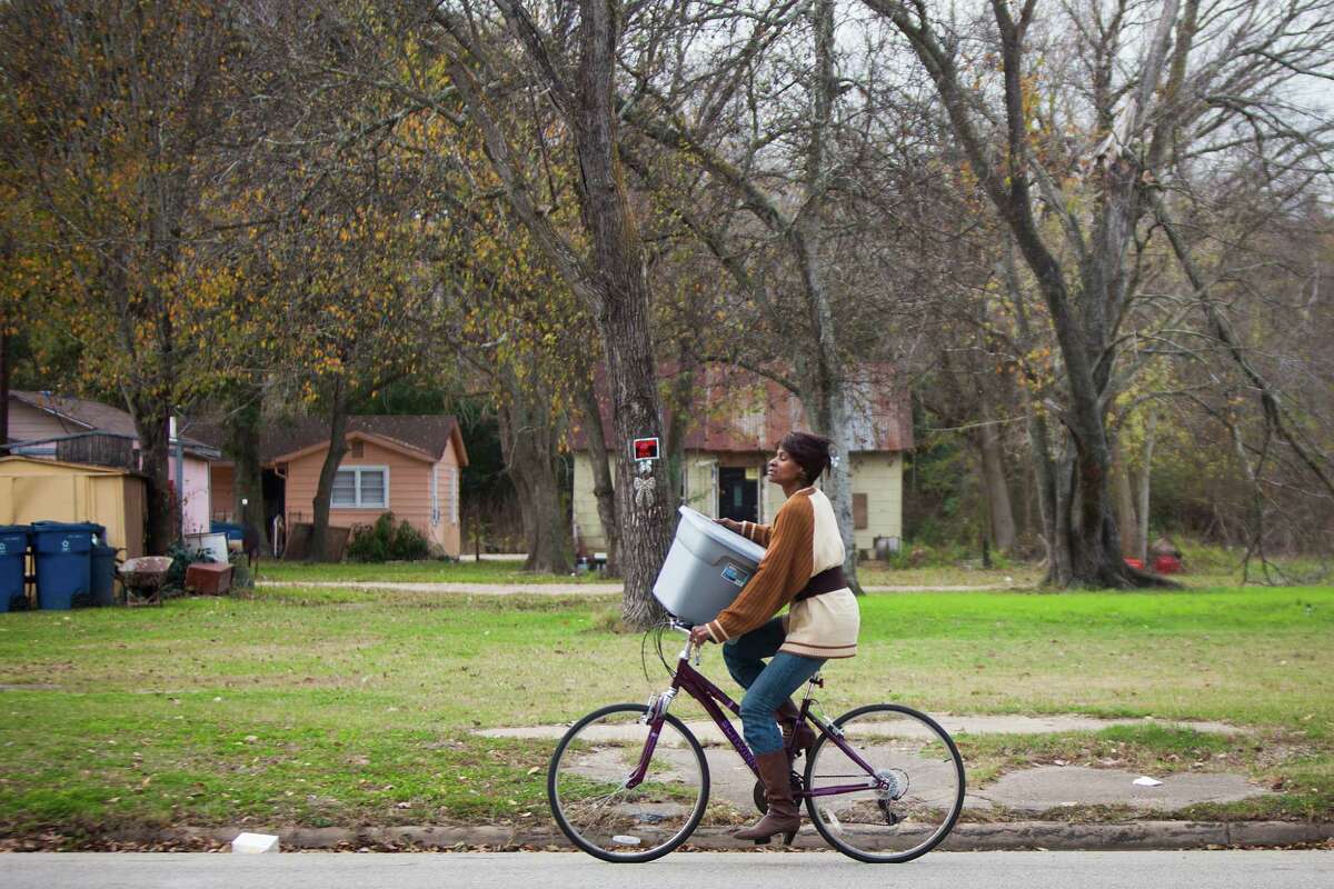 A woman rides a bicycle down Danover Street in Katy﻿ on Wednesday.﻿ Katy has gained a reputation for being unwelcoming to developers of low-income housing.