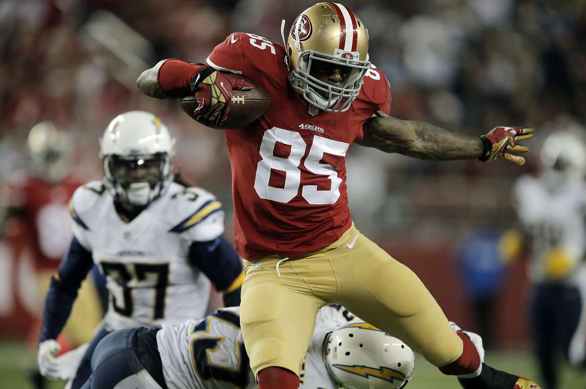 Vernon Davis (85) evades a defender on his way toward the end zone, but the play was called back by a penalty in the third quarter as the 49ers played the San Diego Chargers at Levi's Stadium in Santa Clara, Calif., on Saturday, December 20, 2014.
