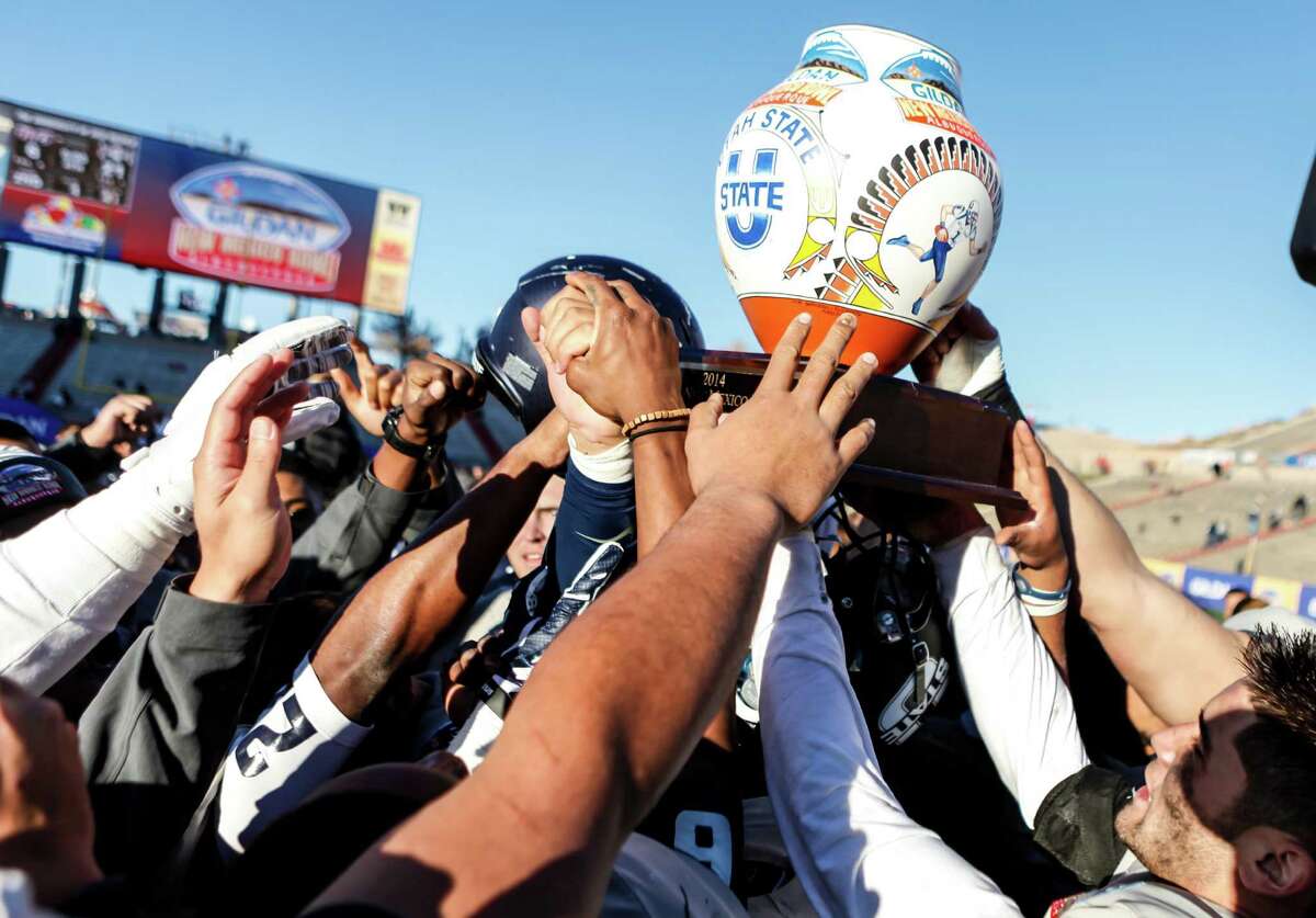 Gildan New Mexico Bowl Utah State 21, UTEP 6 AudioSource Sound portable/mobile speakers, mobile phone chargers, Oakley Works backpacks, Oakley Enduro sunglasses/beanies, caps, and Gildan blankets. The Utah State Aggies hold up the Gildan New Mexico Bowl Trophy after defeating the UTEP Miners on Dec. 20, 2014.