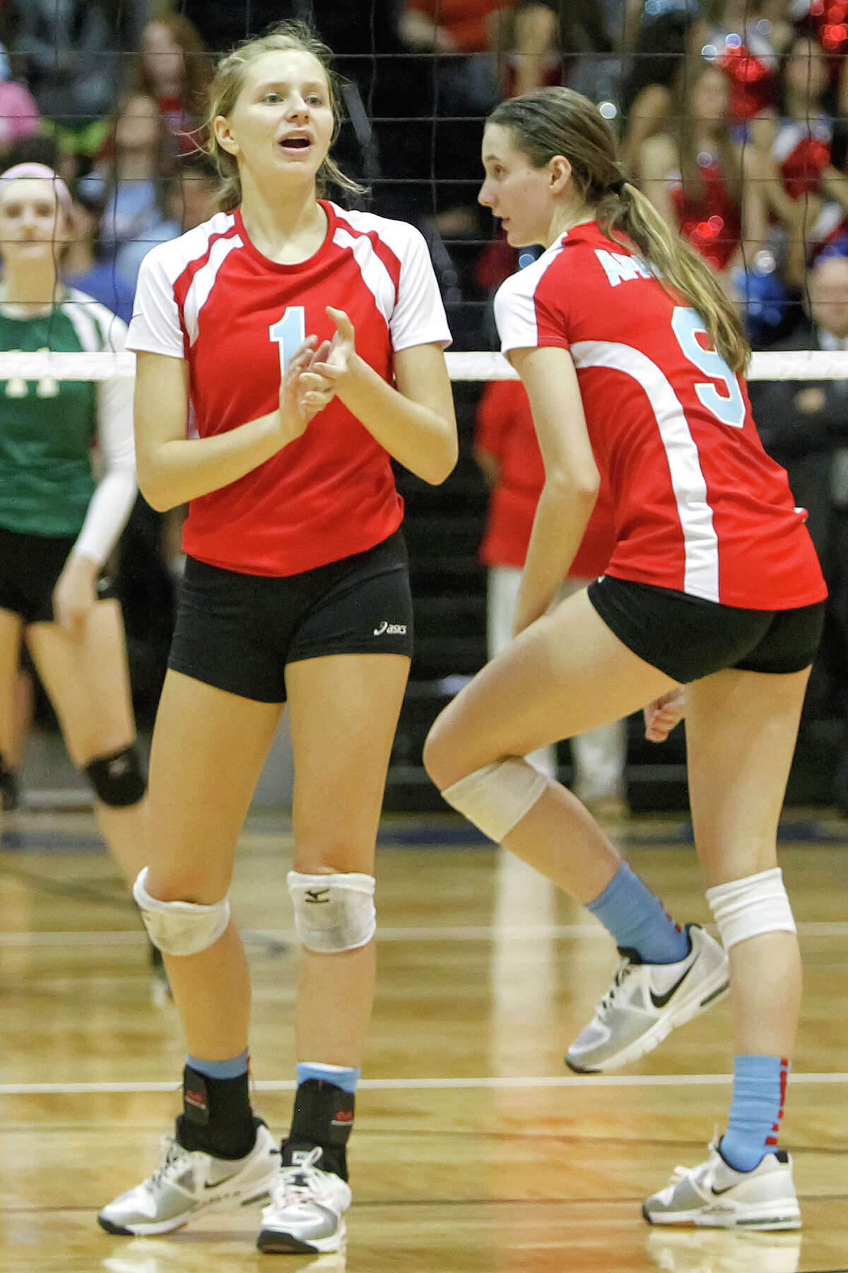 Antonian's Sarah Bell (l) encourages her teammates during a match against rival Incarnate Word at Greehey Arena on Oct. 9, 2013.