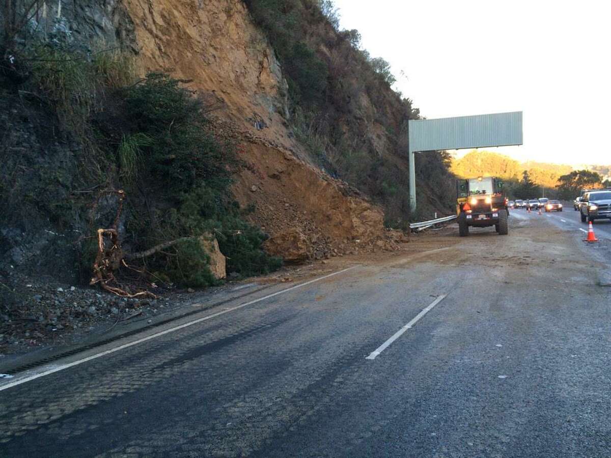 Caltrans crews break up pieces of debris left over from a landslide that spilled into southbound lanes of Highway 101 in Sausalito Monday morning.